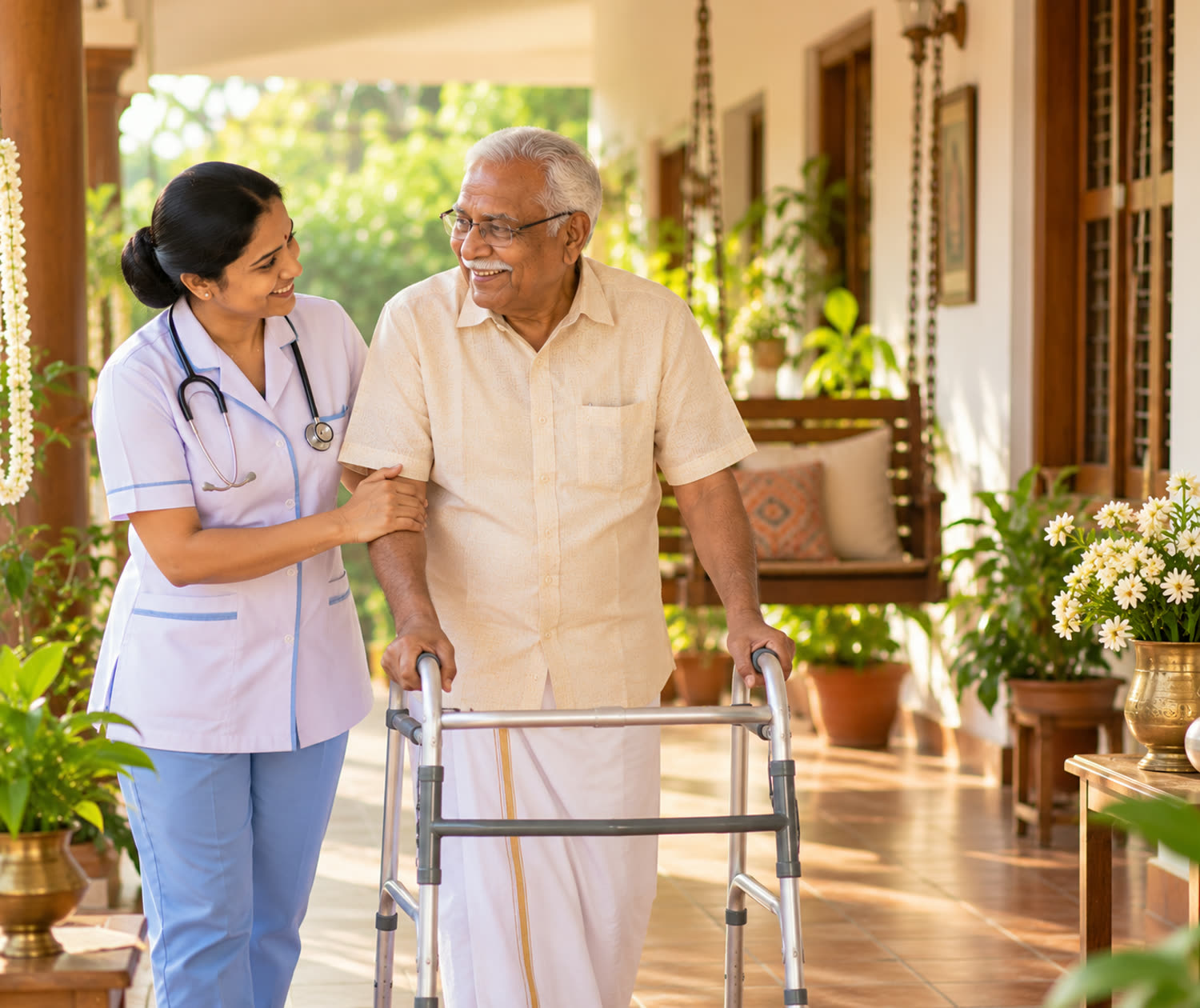 A nurse helping an elderly man walk with a walking frame on a sunlit verandah